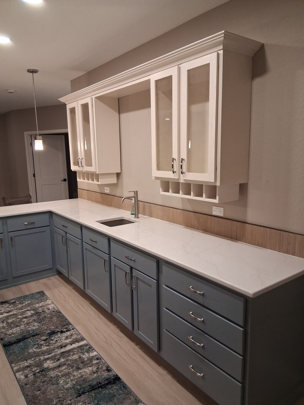 Hand-built custom cabinetry with crown molding, glass uppers and wine cubbies