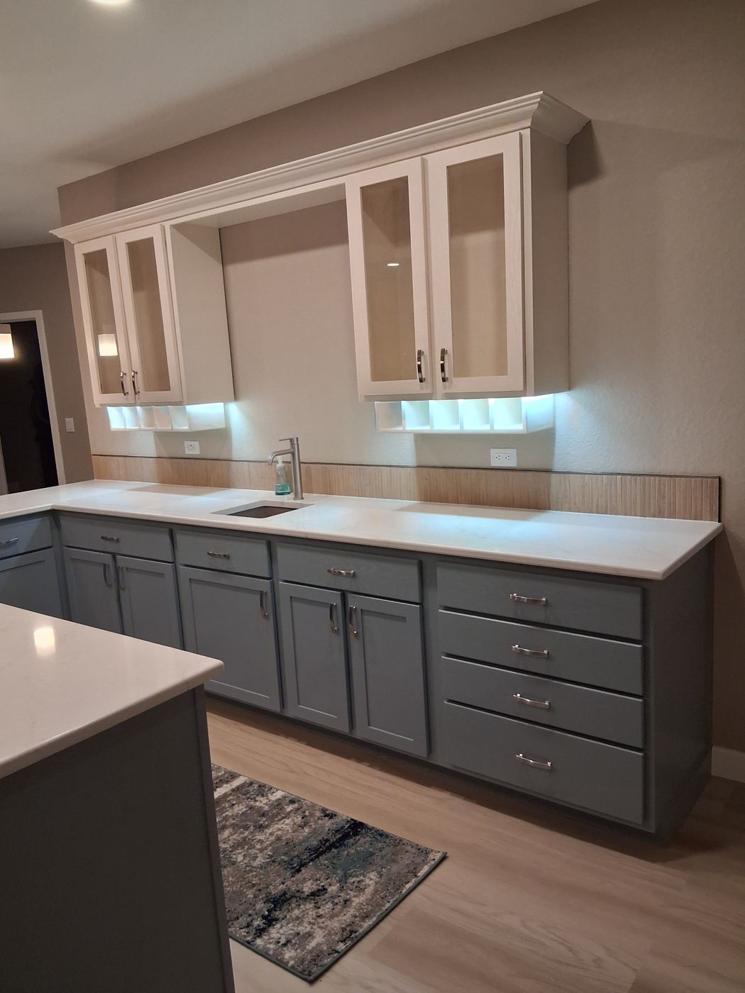 Two-tone cabinetry, blue-gray lowers and white uppers